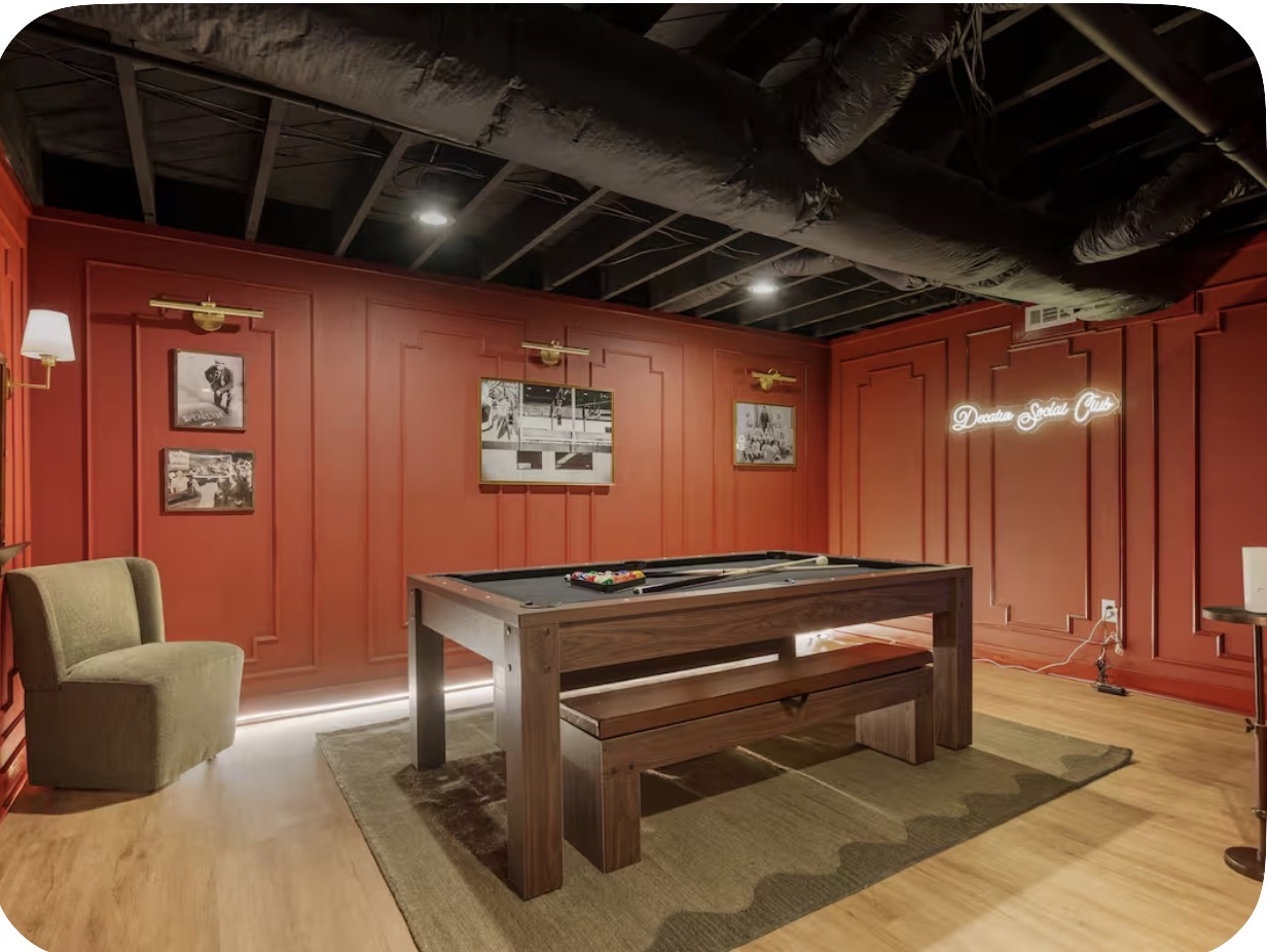 Terracotta paneled basement game room with pool table and neon social club sign